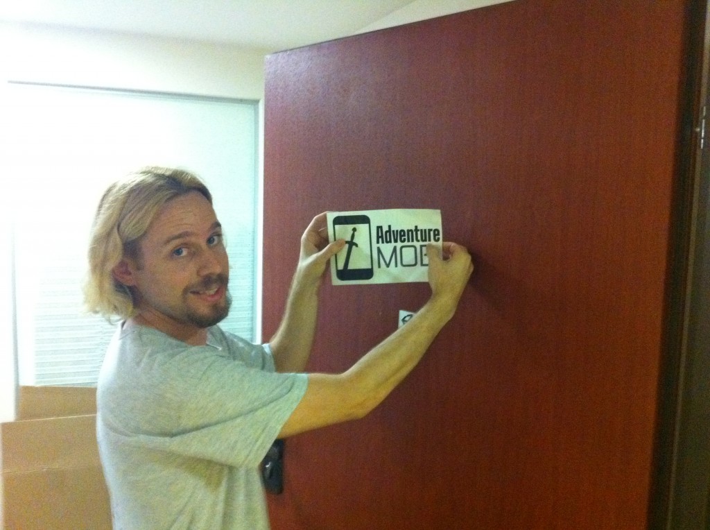 Adventure Mob sign being placed on the front door.